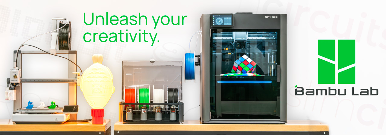 A Bambu Labs H2C and A1 3D Printers sit on a wooden benchtop displaying their recently finished prints.