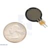 Force-sensing resistor (0.6-diameter circle short tail) with a US quarter for size reference. (SKU: POLOLU-2728 Image 2)