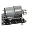 The machined piece of the 6 mm scooter wheel adapter mounted to the output shaft of a 37D mm gearmotor. (SKU: POLOLU-2674 Image 6)