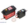 Power HD digital giant servo 1235MG (left) next to a Power HD high-torque standard-size servo 1501MG (right) with a US quarter for size reference. (SKU: POLOLU-2375 Image 2)