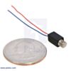 Vibration Motor 11.6x4.6x4.8mm next to a US quarter for size reference. (SKU: POLOLU-2265 Image 3)