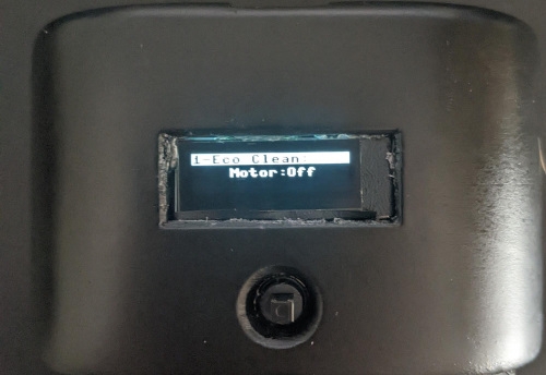 a screen recessed above the vacuum button, onscreen it says 'Eco clean' 'Motor off'