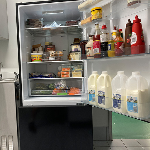an image of a fridge door open with several food items inside.